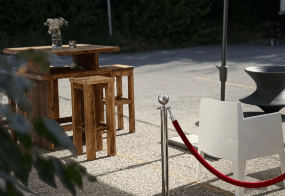 Cocktail Table, Bar Stool made of reclaimed wood, and Toy armchair by Philippe Starck at an event