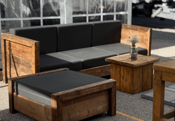 Sofa, ottoman, and side table made of construction wood at an event