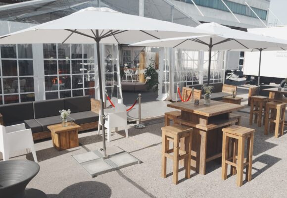 Cocktail Table, Bar Stool made of reclaimed wood, and Toy armchair by Philippe Starck at an event